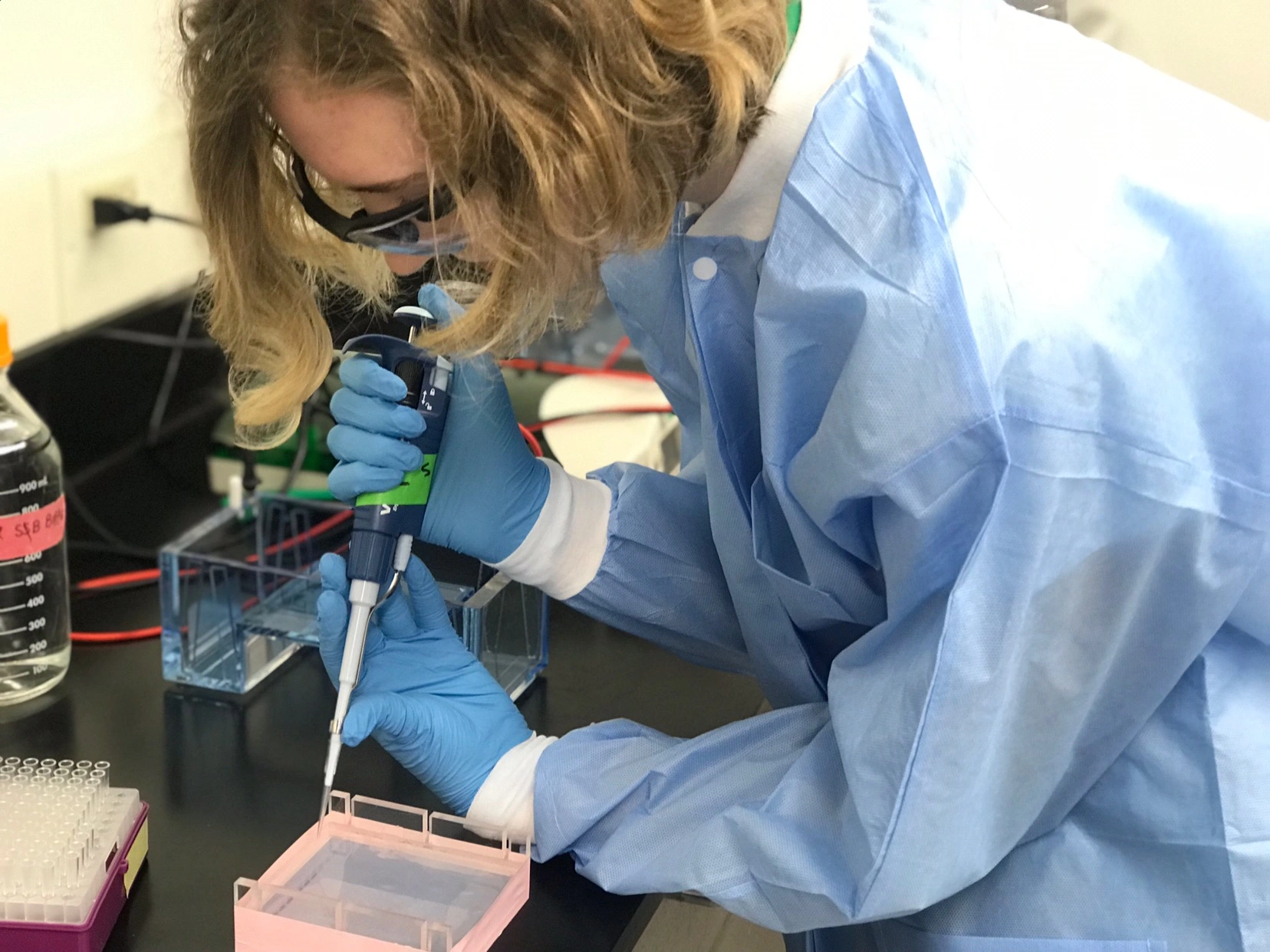 Students make the Heisman pose inside the Bright Football Complex.